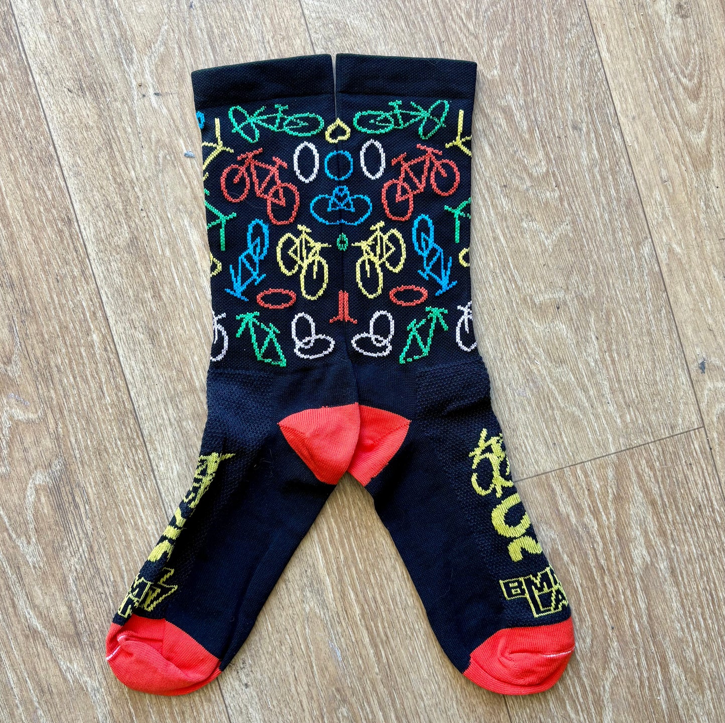 Colorful bicycle-patterned socks on a wooden floor