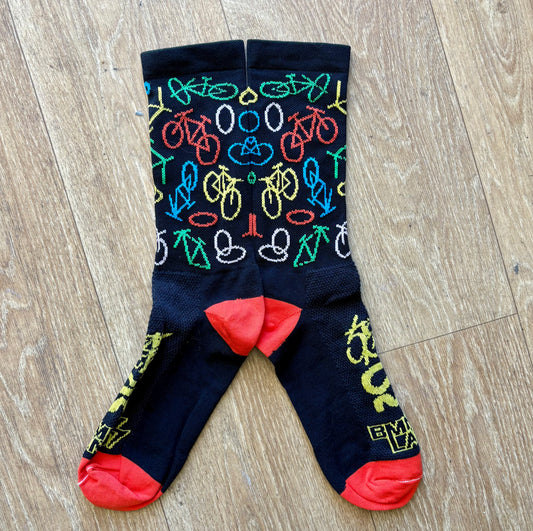 Colorful bicycle-patterned socks on a wooden floor